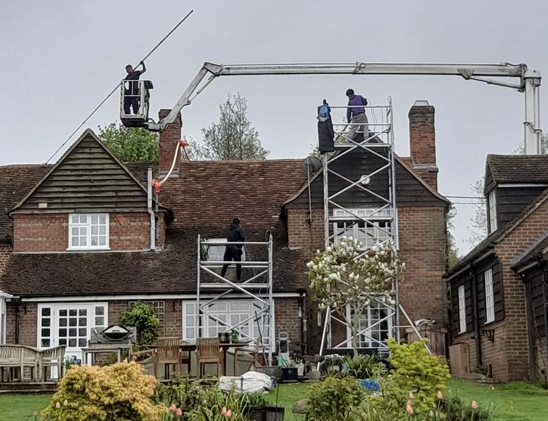 The Roof Moss Cleaners using cherry picker and scaffolding to clean roof safely and professionally in Wisbech, Cambridgeshire